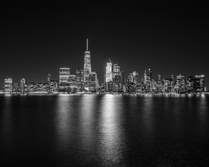 Fototapeta na wymiar New York City skyline in black and white with reflections in the water.