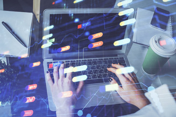 Double exposure of woman hands working on computer and data theme hologram drawing. Tech concept.