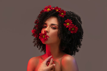 Beauty afro girl with flowers in hair.