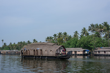 Fototapeta na wymiar River view and traditional house boat in Kerala's Backwaters, India.