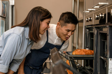 lifestyle background of happy asian couple husband and wife having goodtime together in kitchen preparing food for launch