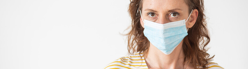  woman putting on a medical mask coronavirus protection