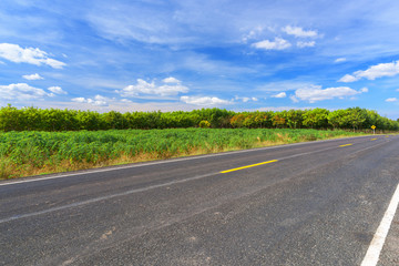 Fototapeta na wymiar Asphalt road and landscape countryside with blue sky.