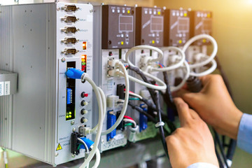 View of communication ports on servo controller in control box of automation machine.