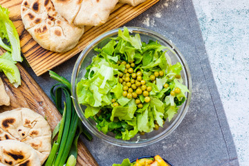 Green herbal leaves fresh detox salad in glass bowl. Vegan, vegetarian healthy diet food