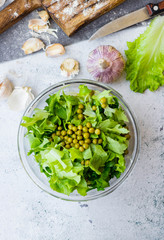 Green herbal leaves fresh detox salad in glass bowl. Vegan, vegetarian healthy diet food