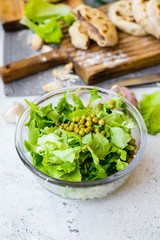 Green herbal leaves fresh detox salad in glass bowl. Vegan, vegetarian healthy diet food