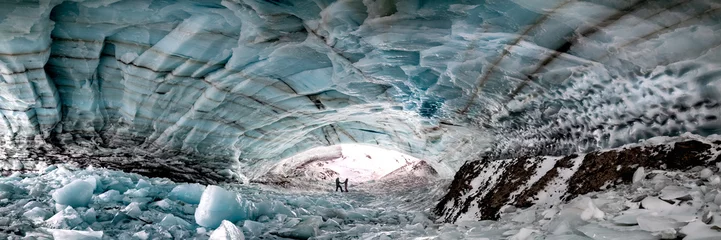 Tableaux ronds sur aluminium brossé Canada Historic ice cave located outside of Haines Junction in Kluane National Park, Yukon Territory with a couple, two people holding hands in love, romantic panoramic view. 