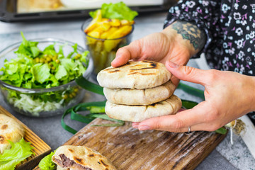Tortilla mexican bread cakes stuffed with red kidney beans filling. Lobiani homemade georgian traditional pie. Vegan, vegetarian food. Woman hands
