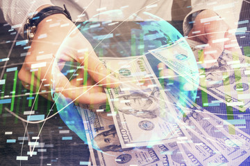 Multi exposure of financial theme drawing hologram and USA dollars bills and man hands. Business concept.