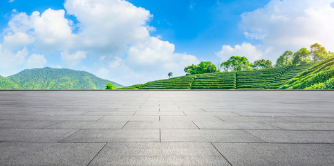 Empty square floor and green tea mountain nature landscape on sunny day,panoramic view.