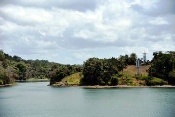 Fototapeta na wymiar Green landscape of Panama Canal, view from the transiting cargo ship.