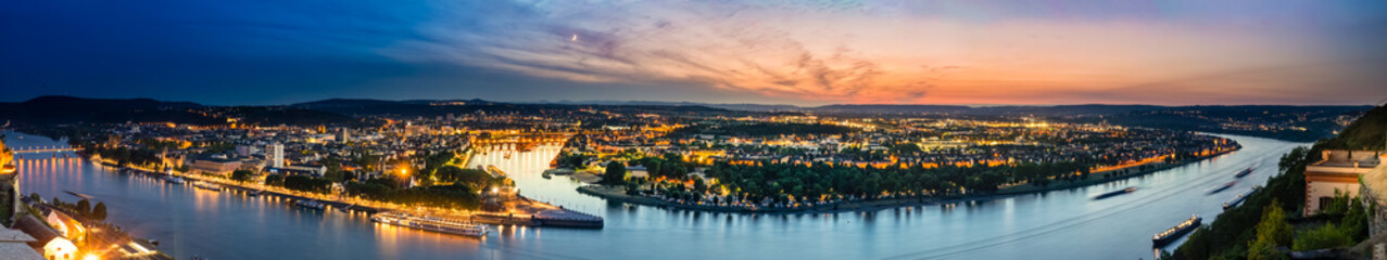 Panorama of beautiful Cologne in Germany at night; cityscape by the Rhine 