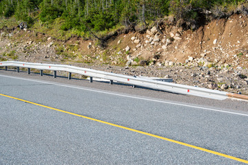 dry asphalt road with marking lines in forest, road trip to mountains