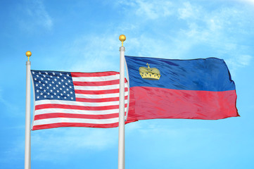 United States and Liechtenstein two flags on flagpoles and blue cloudy sky