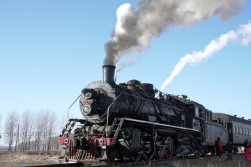 Fototapeta na wymiar Train ready to leave, close up of steaming locomotive