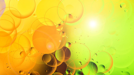 bright oily drops in water with colorful background, close-up