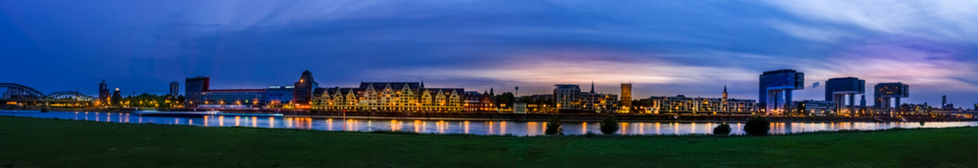 Fototapeta premium Panorama of beatiful night view: Cityscape and lakescape at nightfall in Cologne of Germany
