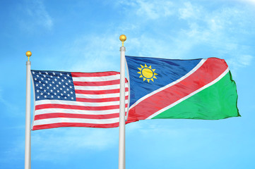United States and Namibia two flags on flagpoles and blue cloudy sky