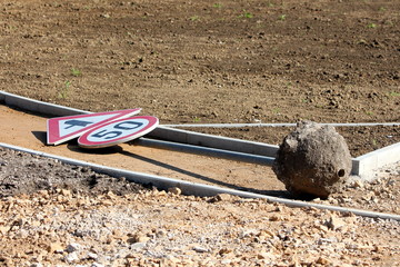 Knocked over old road sign for 50 speed limit and triangle traffic merges ahead onto main...