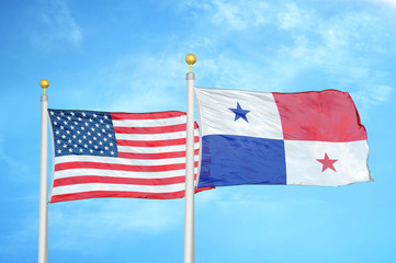 United States and Panama two flags on flagpoles and blue cloudy sky