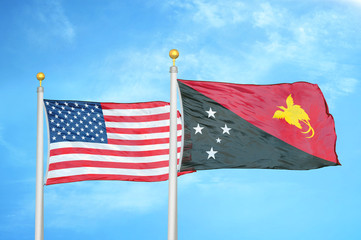 United States and Papua New Guinea two flags on flagpoles and blue cloudy sky