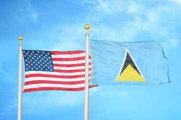 United States and Saint Lucia two flags on flagpoles and blue cloudy sky