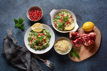 Healthy salad with couscous, fresh mint, cucumber, pomegranate, lemon and olive oil. Eastern cuisine. Vegan food concept. Traditional Israeli food