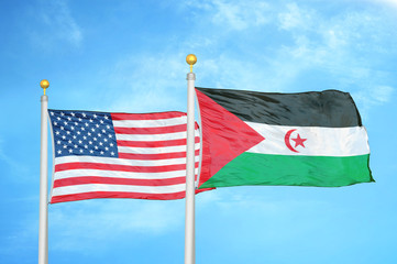 United States and Western Sahara two flags on flagpoles and blue cloudy sky