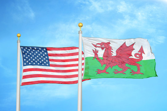 United States and Wales two flags on flagpoles and blue cloudy sky