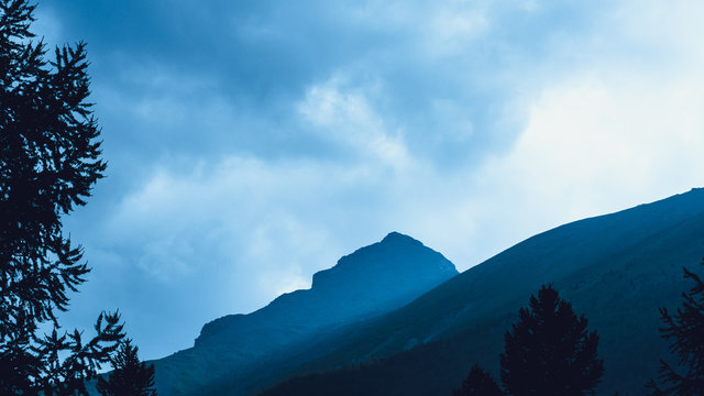 high cliffs in blue haze, silhouette of mountain range in fog, meditation and relaxation in nature