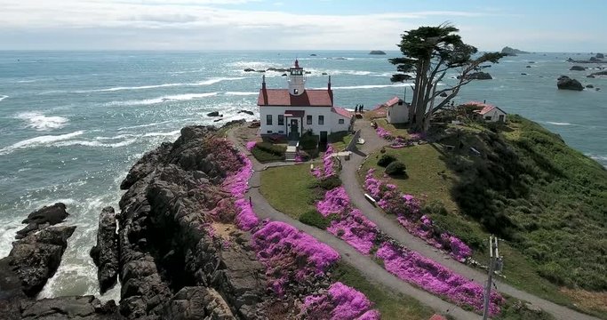 Flying around lighthouse at Crescent City, CA. Flying around lighthouse at Crescent City, northern California, with spring flowers in bloom.