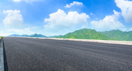 Asphalt road and green mountain nature landscape on sunny day,panoramic view.