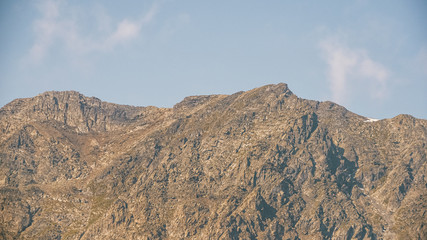 Fototapeta na wymiar rocky mountains on horizon, valley for hiking and tourism