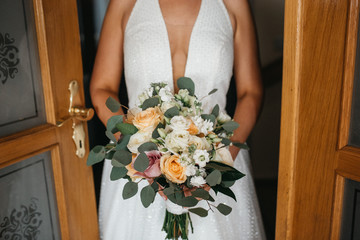  Beautiful bride in wedding dress with bouquet in hand
