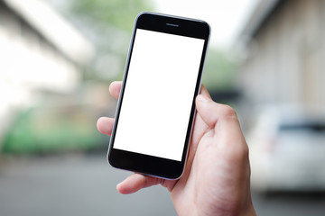 Cropped shot view of man hands holding smart phone with blank copy space screen for your text message or information content, female reading text message on cell telephone during in urban setting.