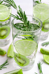 Transparent drink with fruit and rosemary