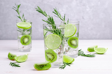 Transparent drink with fruit and rosemary