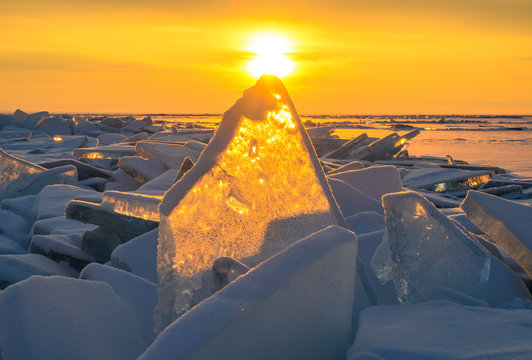 Beautiful landscape of Uzury bay with ice hummock rising above the frozen lake of Baikal at sunrise. Uzury is a very little settlement located on the eastern side of Olkhon island.