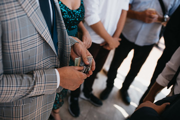  The man in the gray suit gives the money