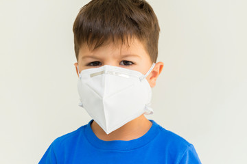 Closeup of caucasian boy wearing surgical mask.