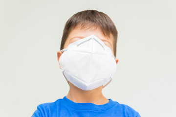 Caucasian boy with surgical mask covering his face.