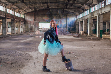 Portrait of a young girl with pink hair standing inside of collapsed building surrounded by ruins