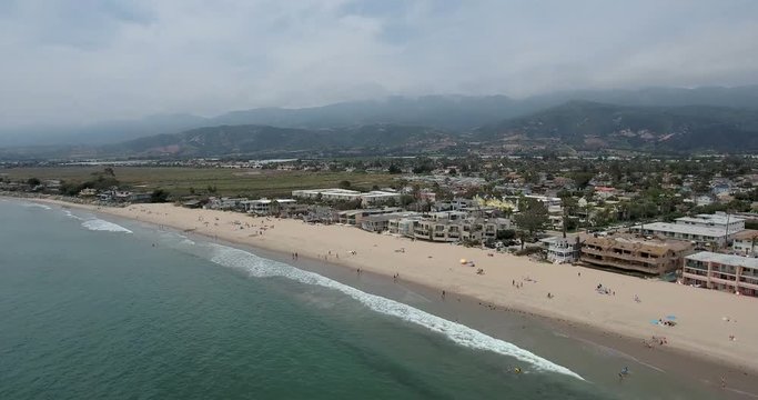 Aerial along world's safest beach near Santa Barbara in Carpinteria, CA.