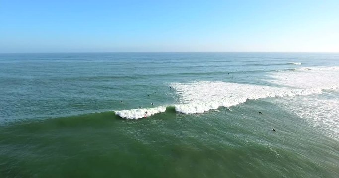 Flying out over surfers at C Street surf spot in Ventura, California.