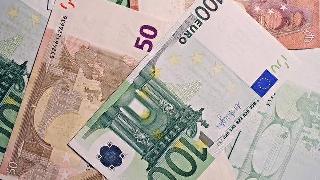 100, 50 10 Euro notes close up macro shot, spinning in frame, 4k studio footage