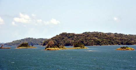 Green landscape of Panama Canal, view from the transiting cargo ship.