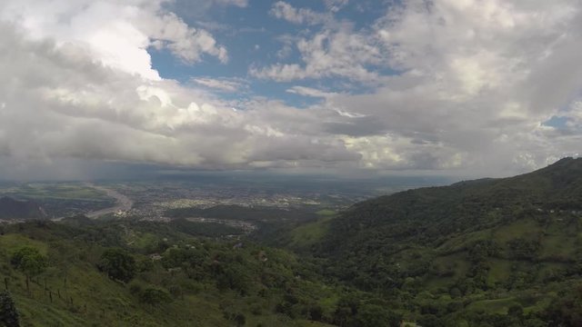 Timelapse from the mountains of Colombia visualizing the city, fast sky changes the weather, large moving clouds.