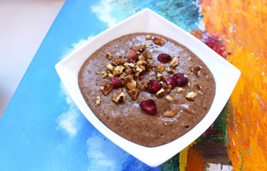 Raw vegan vegetarian food. Flax porridge with walnuts and strawberries. Healthy eating lifestyle. Artist's Breakfast