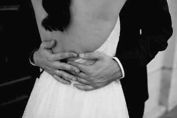  The bride in her wedding dress and the groom in the suit on their wedding day
